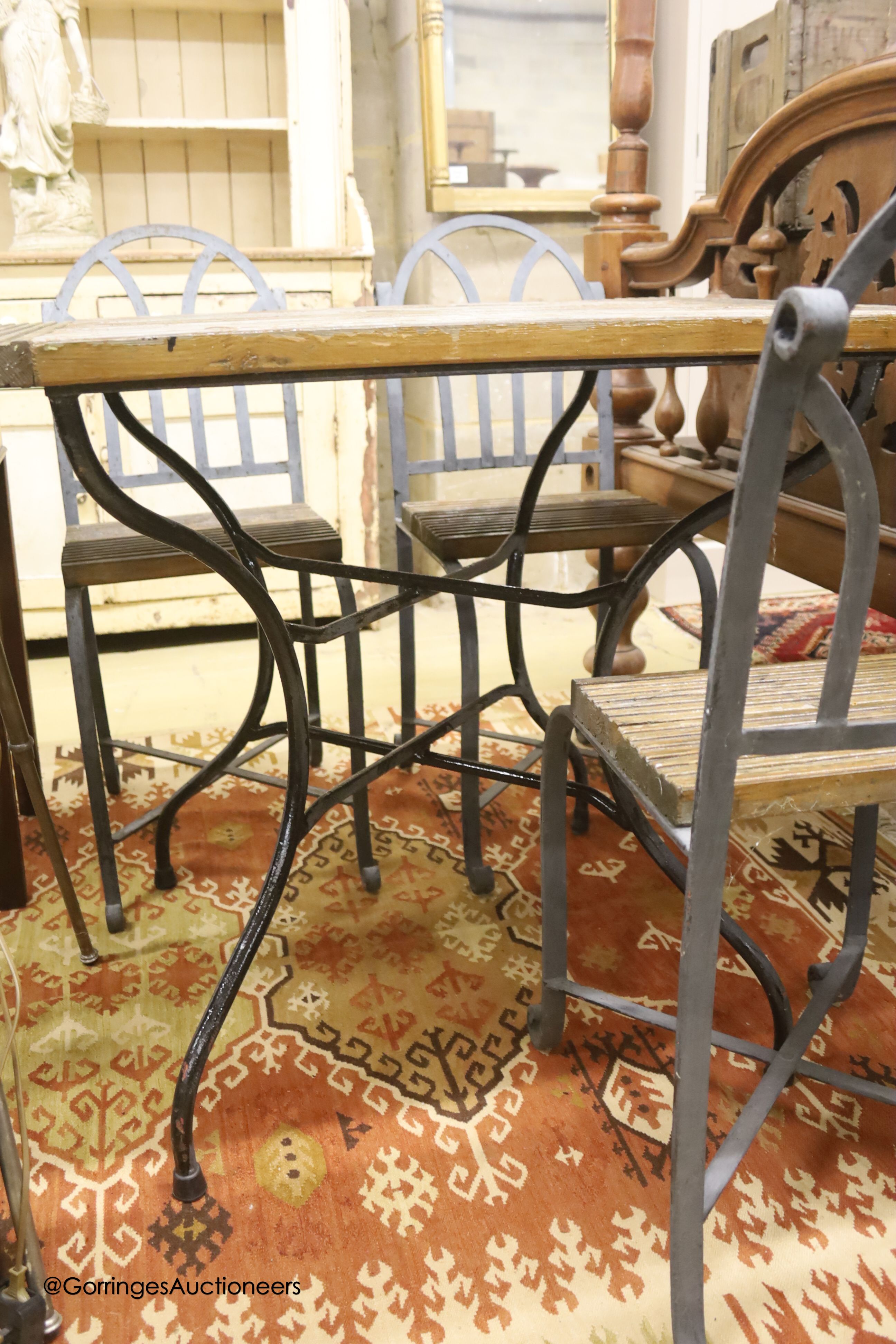 A French slatted wood wrought iron garden table, width 72cm, depth 94cm, height 78cm and four chairs